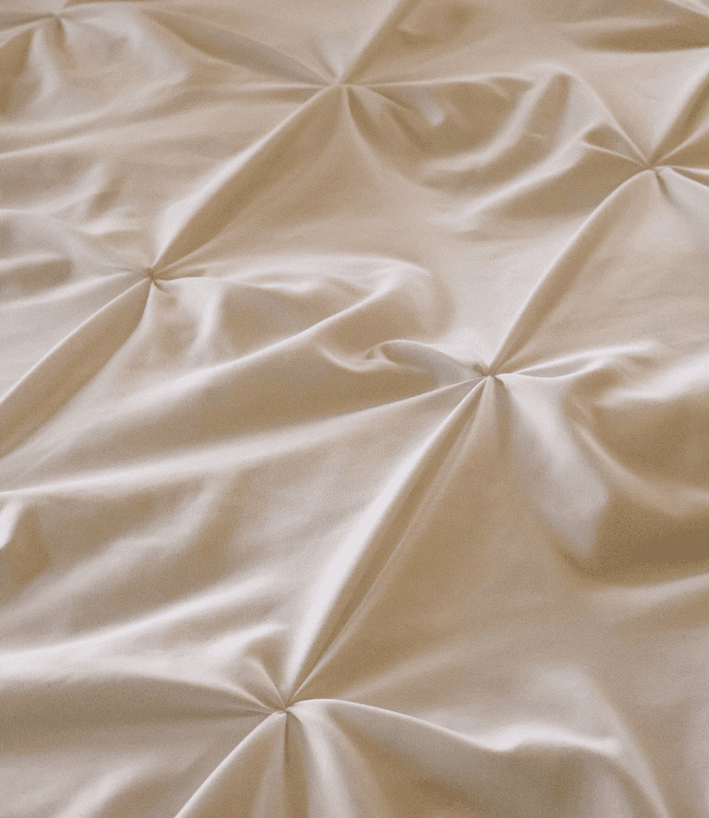 Textured beige fabric with pleats.