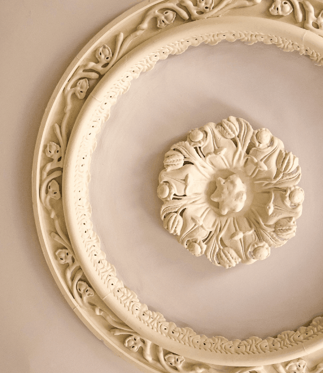 Ceiling medallion featuring intricate floral and ornamental detailing.